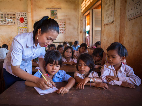 Photo of Teacher with children in class