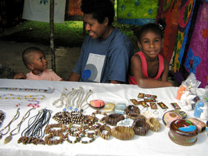 A local souvenir stall on Champagne Beach, Vanuatu sells goods to Carnival cruise tourists