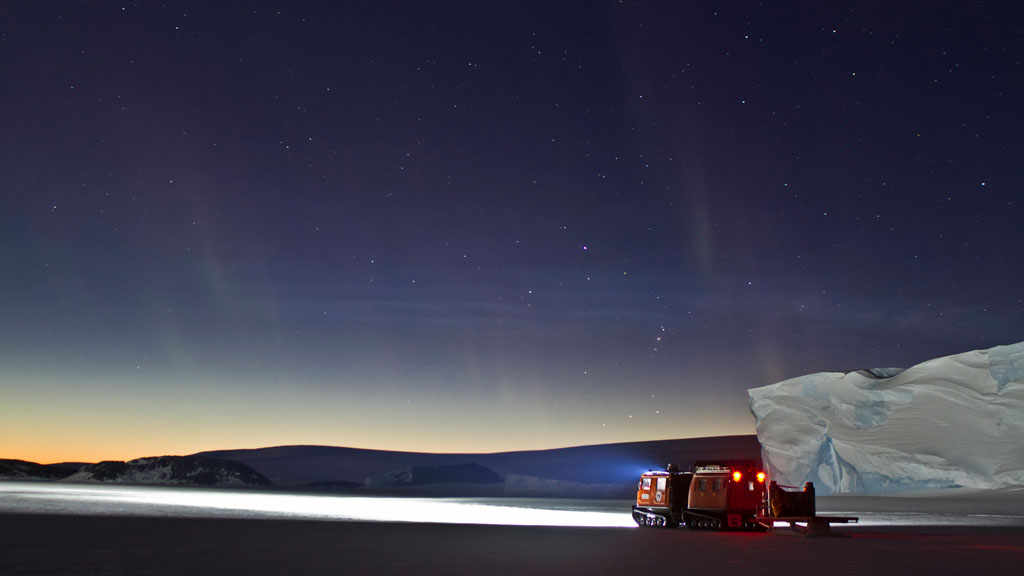 A truck driving through an icey landscape