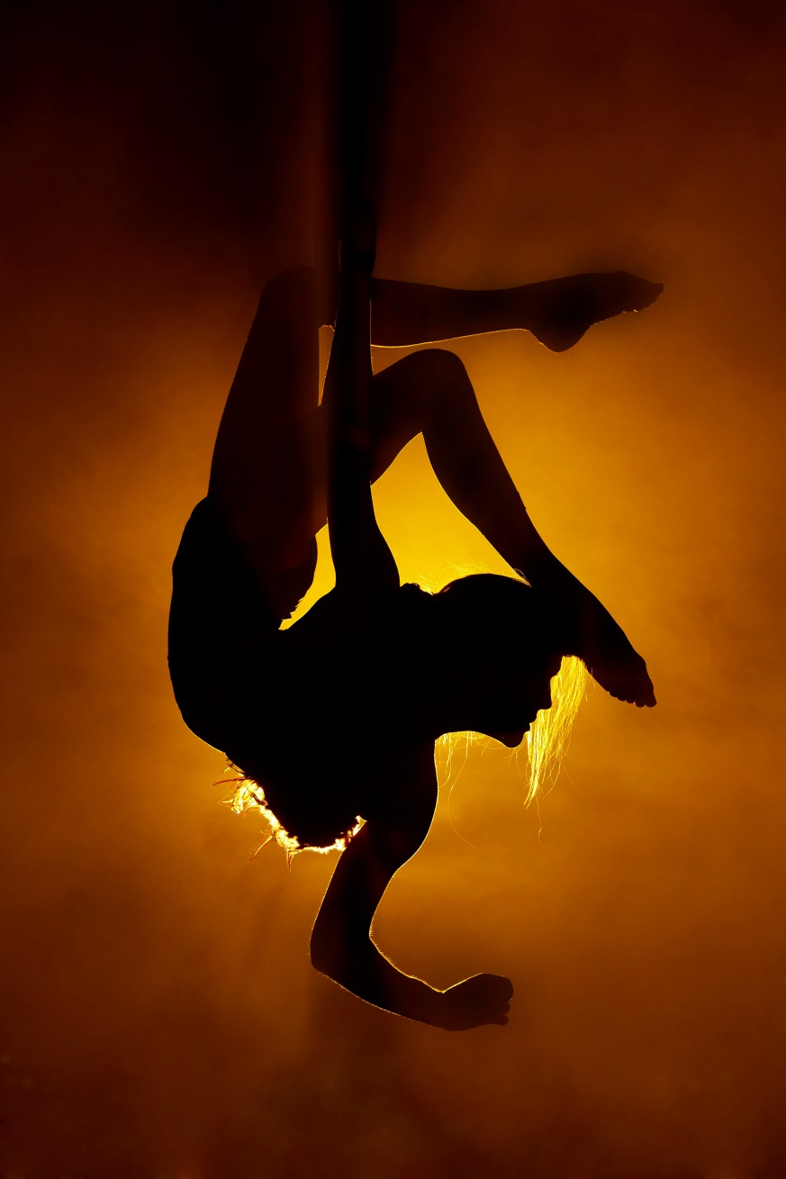 dancer hanging upside down from a ribbon