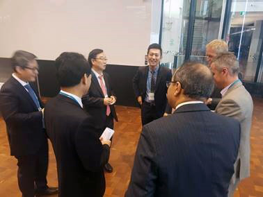 Group of men standing in circle chatting