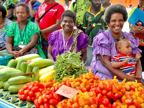 Photo of several women selling their fruits and vegetable at the local Market place