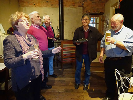 People in a cellar drinking wine and beer