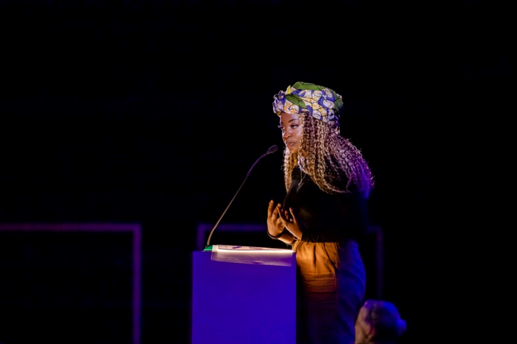 Woman at lectern on stage