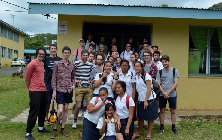 students posing for photo in front of class room
