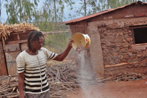 Woman tipping seed from a container