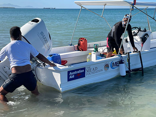 Two people launching a boat