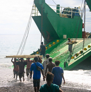 Men unloading cargo on beach