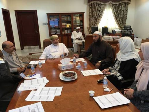 Photo of people sitting around a table in discussion.