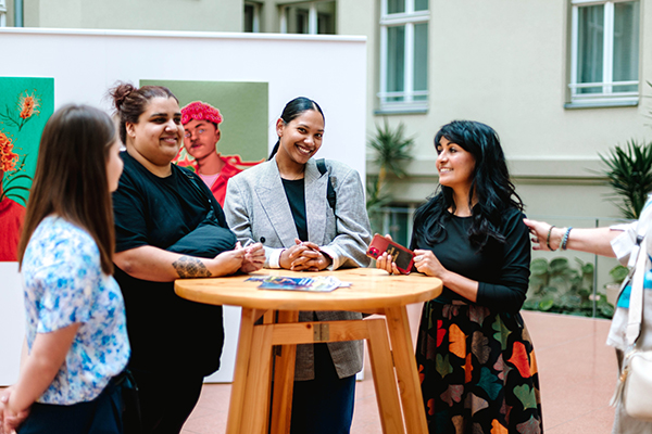 Three people standing around a table