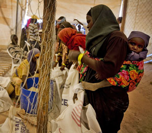 Woman with child at food distribution centre