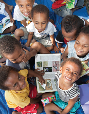 A group of schoolchildren reading books