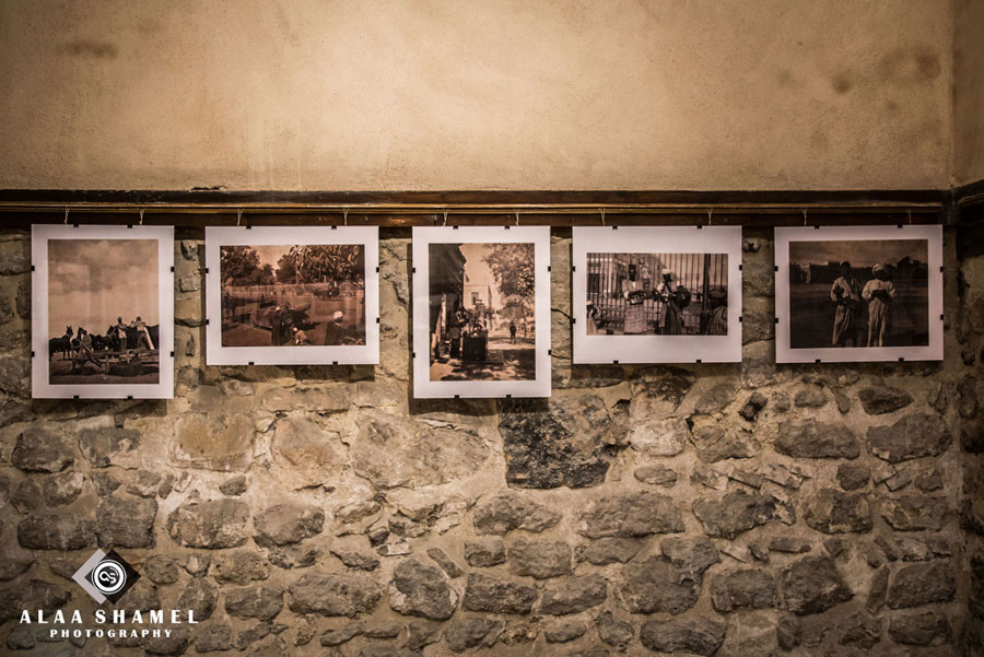 Image of photo exhibition on a stone wall. 