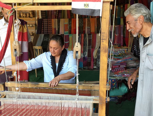 Lee-Ann, trying out traditional weaving on a Nubian loom.