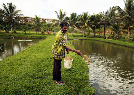 A man standing alongside a river