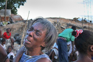 Photo of distressed woman with injured people in background