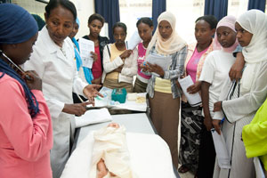 A teacher training students in midwifery