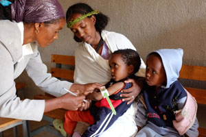 A Government of Ethiopia Health Extension Worker checks for malnutrition by measuring the Middle Upper Arm Circumference of a child at a health centre in Tigray, Northern Ethiopia.