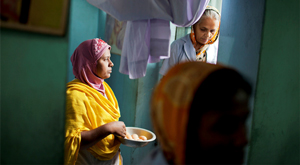 Pregnant woman in birthing centre holding bowl of eggs