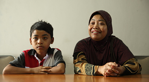 Mothers and child sit at desk