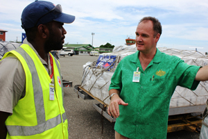 High Commissioner Matt Anderson with Red Cross officer as relief supplies arrive