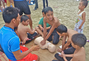 Vietnamese children practicing resuscitation on a dummy