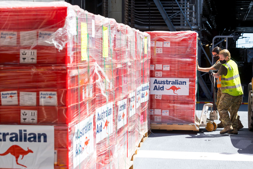 Emergency relief supplies being prepared for offloading from HMAS Adelaide.