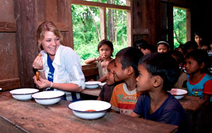 Jessica Watson eats snack with school children