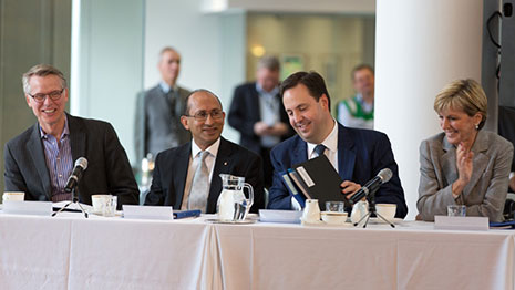 The judges seated at a table while Parliamentary Secretary Ciobo opens the envelope containing the winners