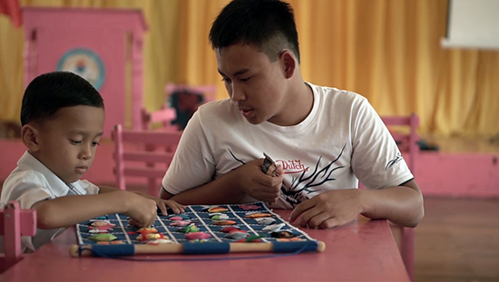 Kindergarten learner Jericho, who has a learning disability, is assisted by his classmate, Nikki Paul, to understand their maths lessons