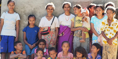 Members of the Puay family in front of their new water tank.