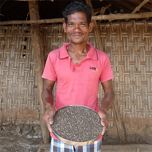 Man holding a container of grain