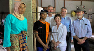 Delegation of 3 men and one woman stand with an Indonesian man and woman