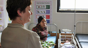Ms Stephens with a woman and baby nearby