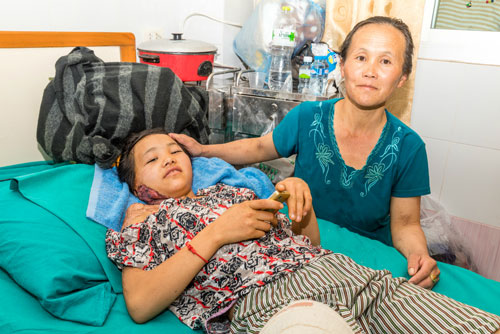 Photo of Houphan recovering after surgery with her mother