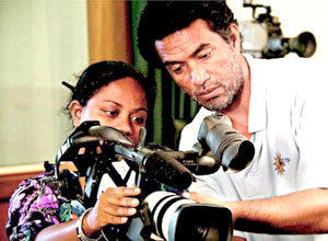 A man and woman holding a video camera
