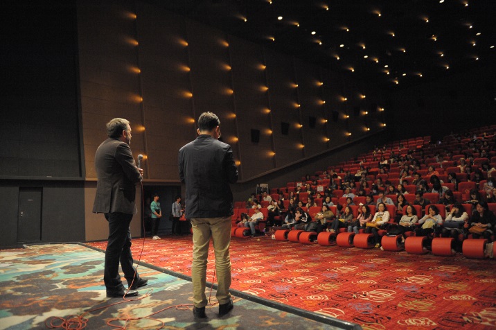 two people on stage facing the audience