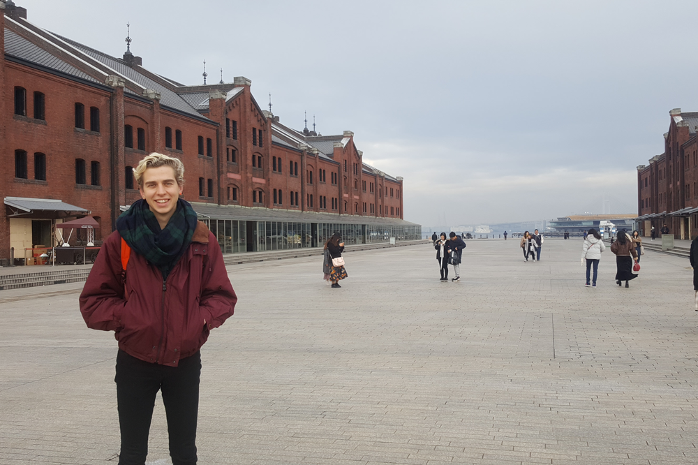 Photo of Luke Macaronas standing in front of Red Brick Warehouses