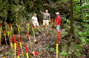 Three people on a mine-cleared site in Peleliu.