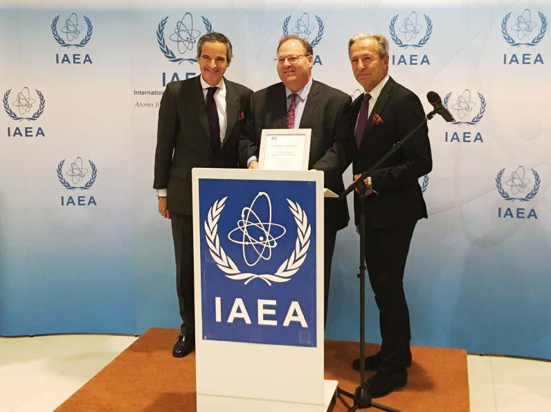 IAEA Director General Rafael Grossi (left), Deputy Director General and Head of the Department of Safeguards Massimo Aparo (right), and Australian Ambassador to the IAEA Richard Sadleir (centre) celebrate the 40th anniversary of the Australian Safeguards Support Program (Credit: IAEA Flickr).