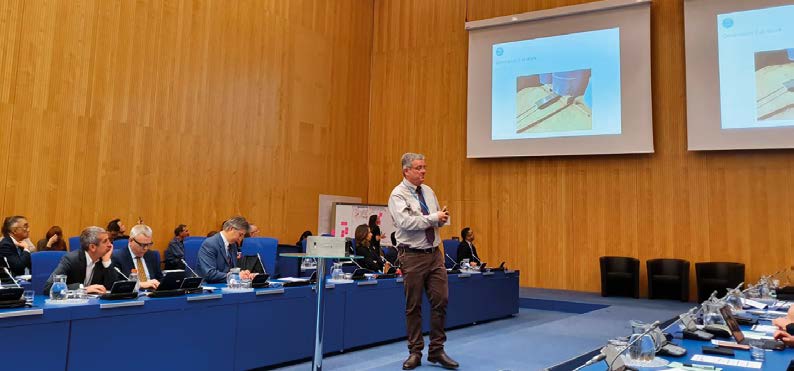 Ross Dungavell of CSIRO's Data61 business unit demonstrates a robot for inspecting drums of radioactive material in densely packed storage installations at the IAEA's Emerging Technologies Workshop in January 2020, Vienna.
