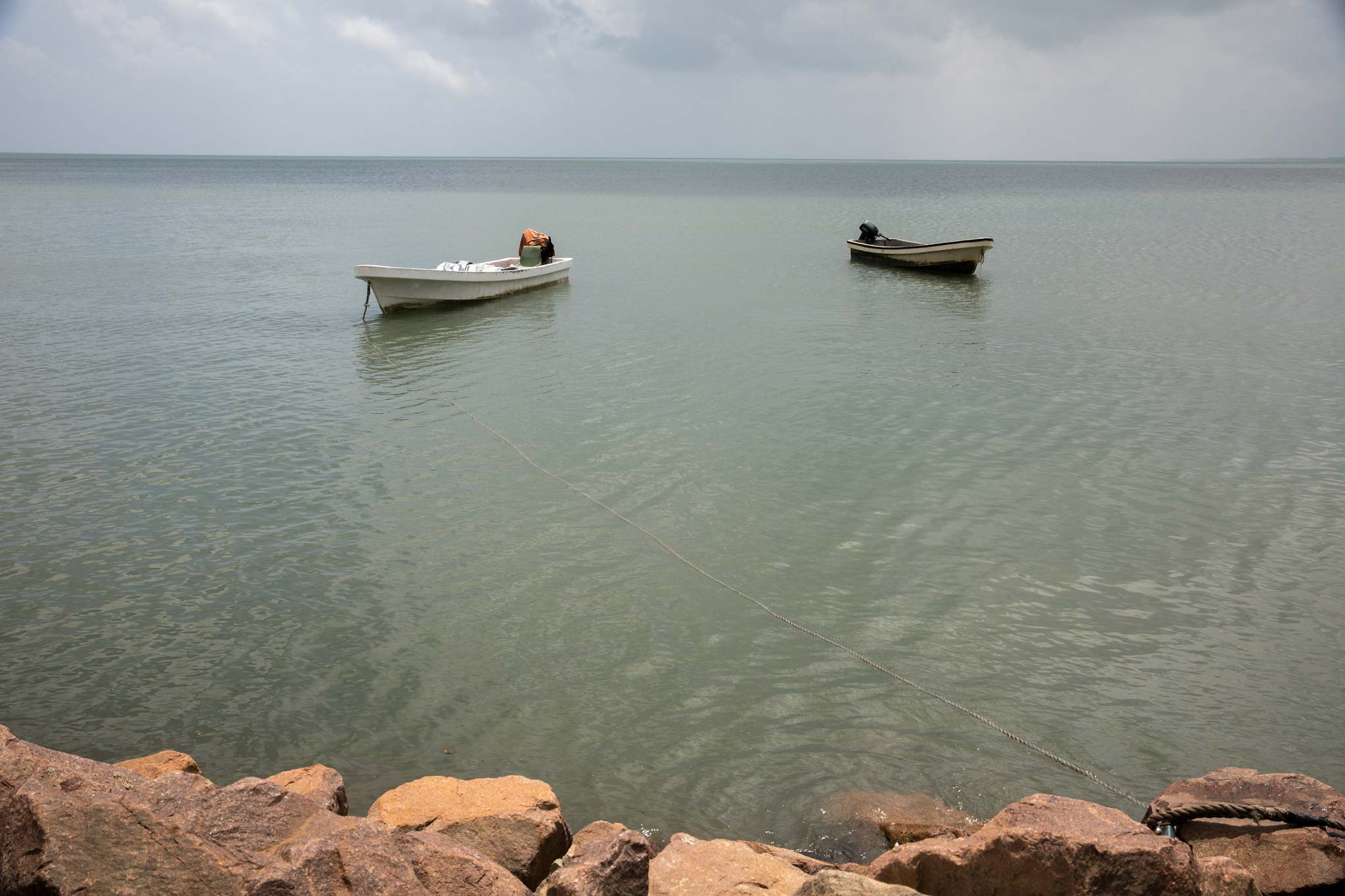 Two empty boats floating on the ocean
