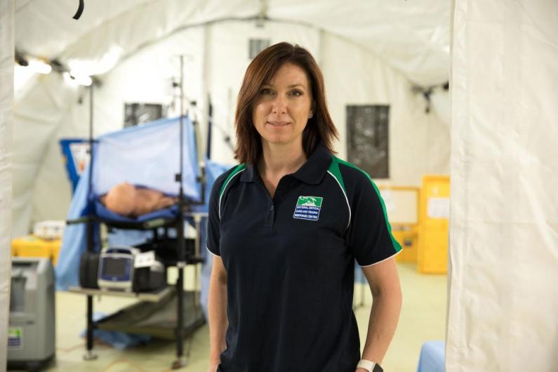Abigail Trewin, inside a temporary operating theatre, with gurney and medical equipment in background