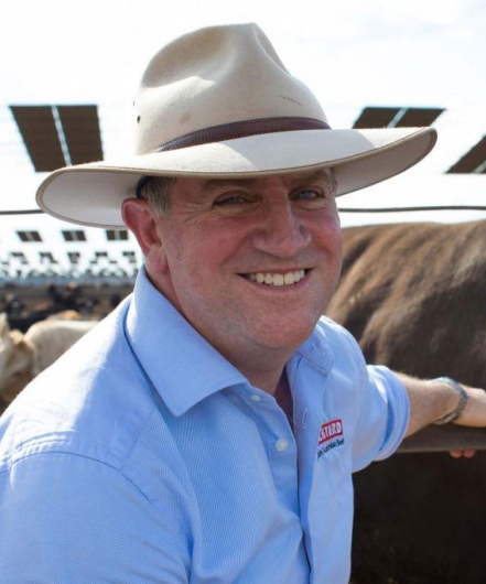 A headshot of Lachie Hart with a cattle yard in background