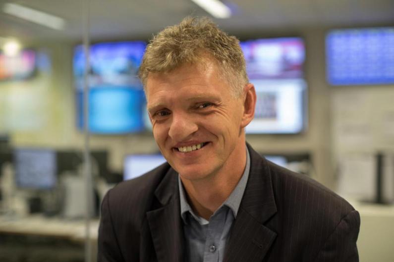 Nigel Stanier headshot, with office in background