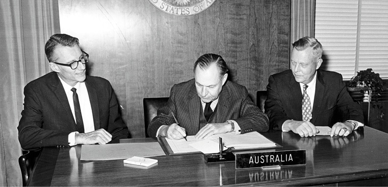 Then Ambassador to the United States and later Secretary (1970–74), Sir Keith Waller (centre), signing the Nuclear Non-Proliferation Treaty, Washington, 27 February 1970. Also present Deputy Director, US Arms Control and Disarmament Agency, Philip Farley (left), and US Under Secretary of State, U. Alexis Johnson