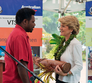 Foreign Minister Julie Bishop congratulates newly-accredited tour operator, Sam Andikar, during her official visit, Vanuatu, 19 December 2013. [DFAT/Graham Crumb]