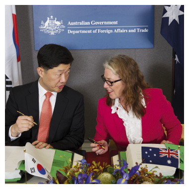Korea–Australia Free Trade Agreement chief negotiator, Jan Adams PSM, initials the agreement with Korean Assistant Minister of Trade, Industry and Energy, Canberra, 10 February 2014