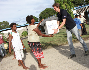 Third Secretary in Honiara, Tao van Wieringen, helps to distribute aid at an evacuation centre following the floods in Solomon Islands, Honiara, 9 April 2014. [DFAT]