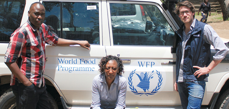 Staff from the High Commission in Nairobi, Solomon Ngari (left), Caroline Mbuguga (centre) and Josef Rafalowicz, visit one of the Australian-supported WFP School Feeding Program sites, Nairobi, 17 October 2013. [DFAT]